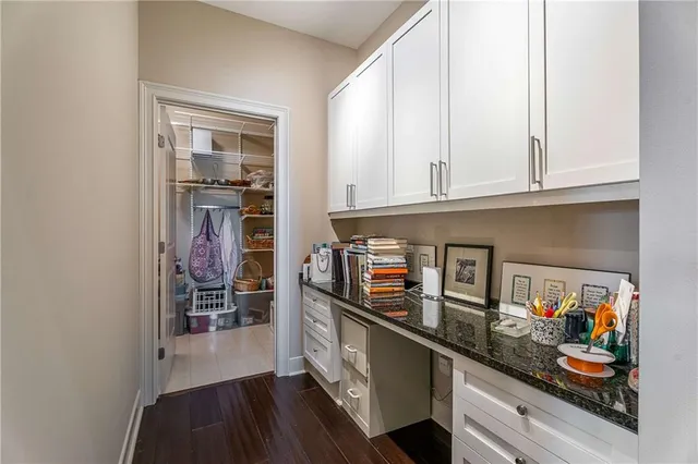 a hallway with dining area and chandelier