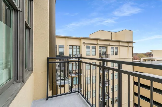 a balcony with table and chairs