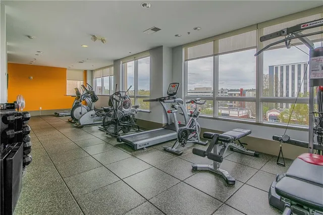 a view of a dining room with furniture a chandelier and a large window