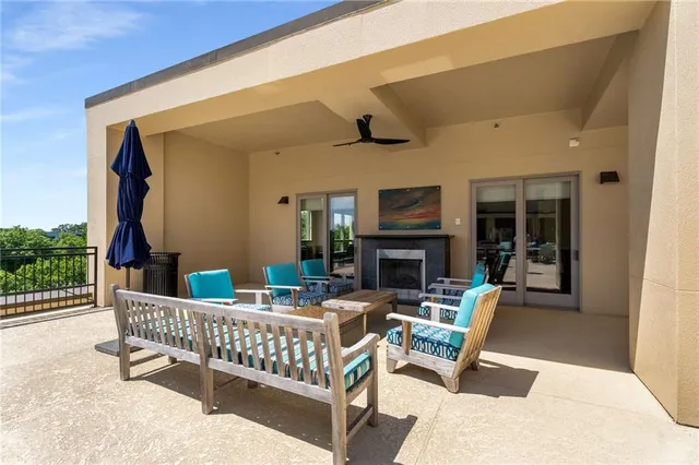 a view of a patio with table and chairs with wooden floor and fence