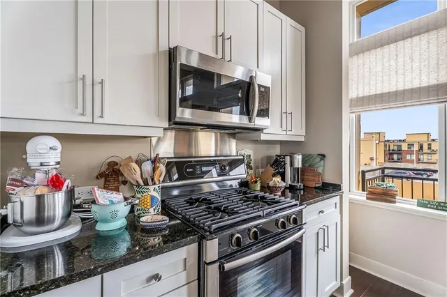 a kitchen with granite countertop stainless steel appliances and cabinets