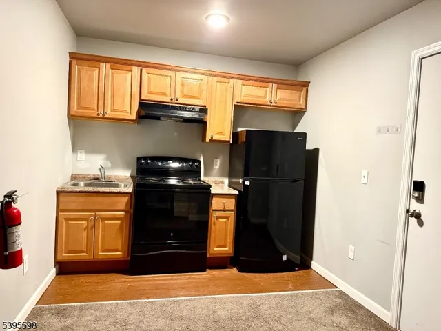 a kitchen with stainless steel appliances granite countertop a refrigerator and a stove