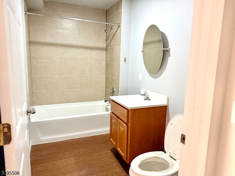 100 Sparta Avenue, Unit 22 Newton, NJ 07860 - Photo 3 of 6 a bathroom with a sink a toilet and a mirror