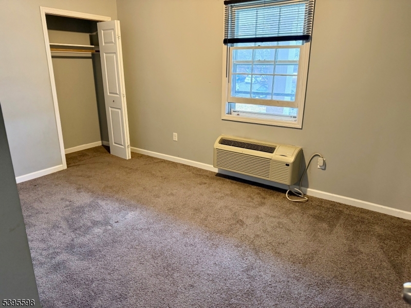 100 Sparta Avenue, Unit 22 Newton, NJ 07860 - Photo 4 of 6 an empty room with windows and closet