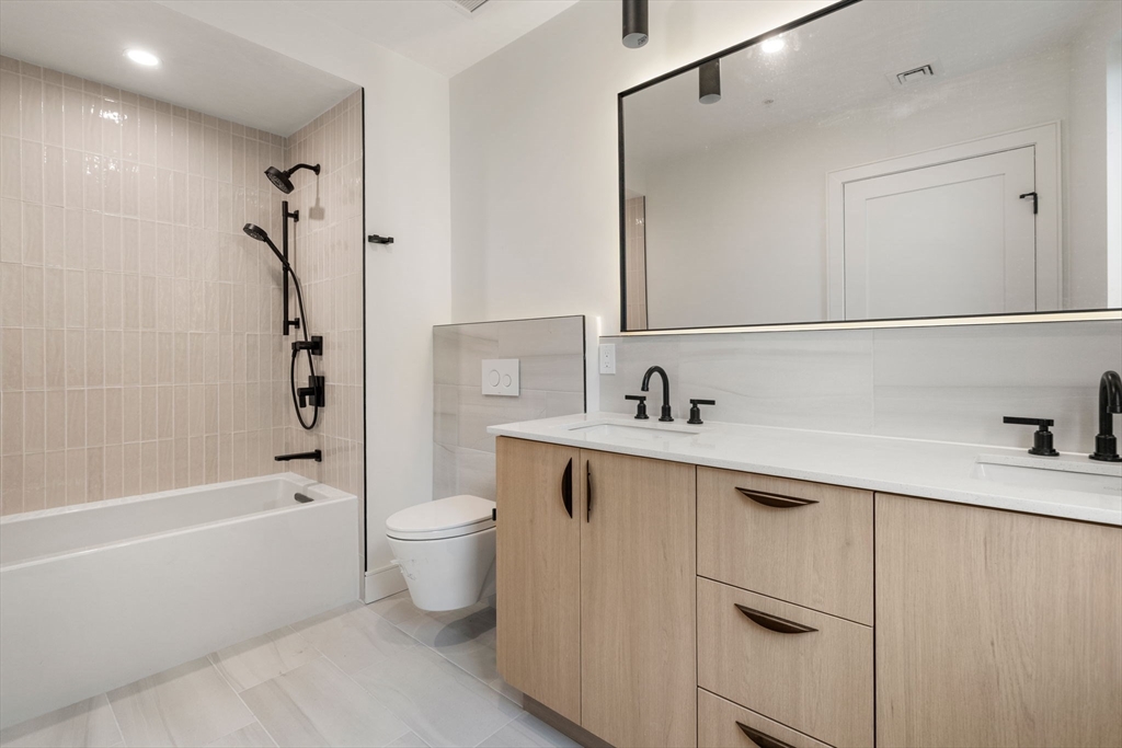 58 Kent, Unit 304 Brookline, MA 02445 - Photo 11 of 19 a bathroom with a sink a toilet and shower