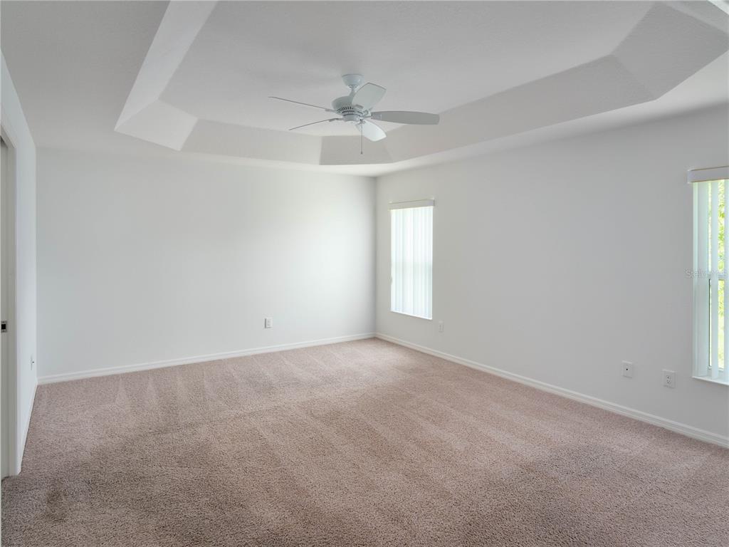 3942 Zenith Loop The Villages, FL 32163 - Photo 17 of 31 an empty room with windows and fan