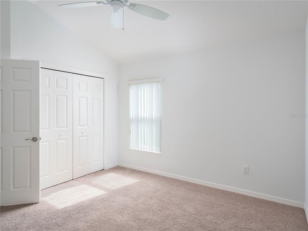 3942 Zenith Loop The Villages, FL 32163 - Photo 23 of 31 an empty room with windows and fan