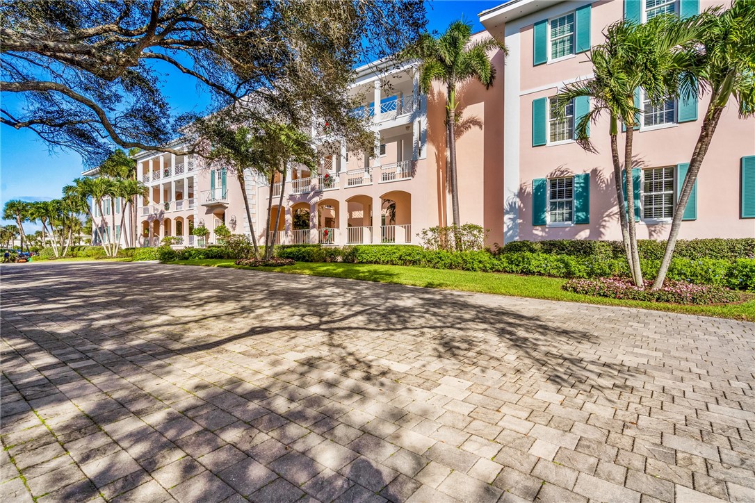 800 Beach Road, Unit 372 Indian River Shores, FL 32963 - Photo 34 of 35 a view of a white building among the street with palm trees