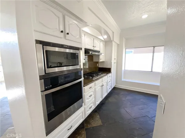 a kitchen with stainless steel appliances and cabinets