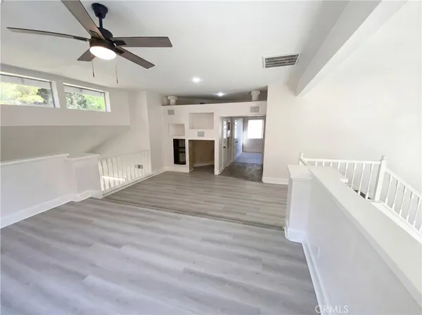 a view of kitchen and hall with wooden floor