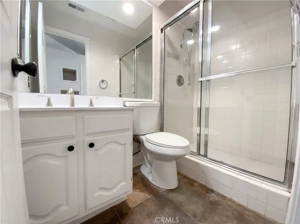 a bathroom with a toilet sink and shower