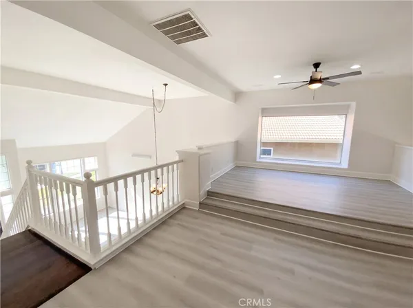 a view of entryway and hall with a ceiling fan