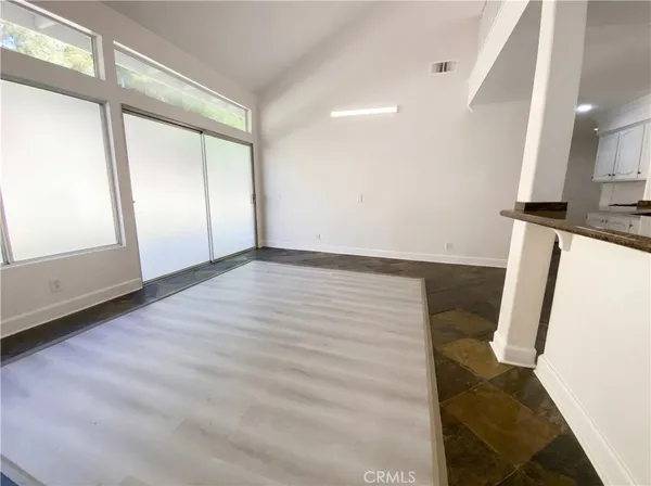 a view of a kitchen with wooden floor and staircase
