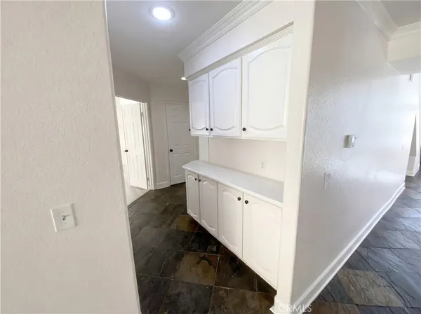 a view of walk in closet with wooden floor