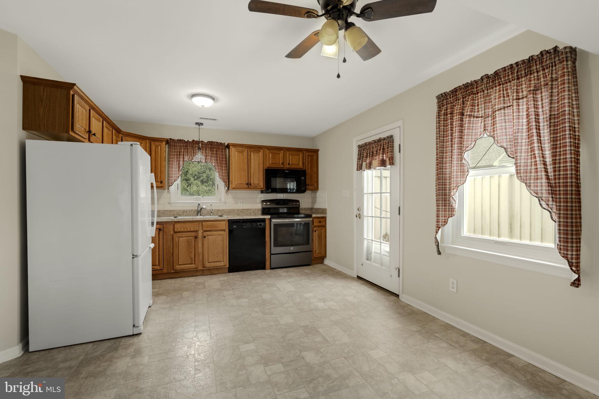 136 Bridle Path New Holland, PA 17557 - Photo 6 of 38 a kitchen with stainless steel appliances a refrigerator a sink a stove a microwave and island