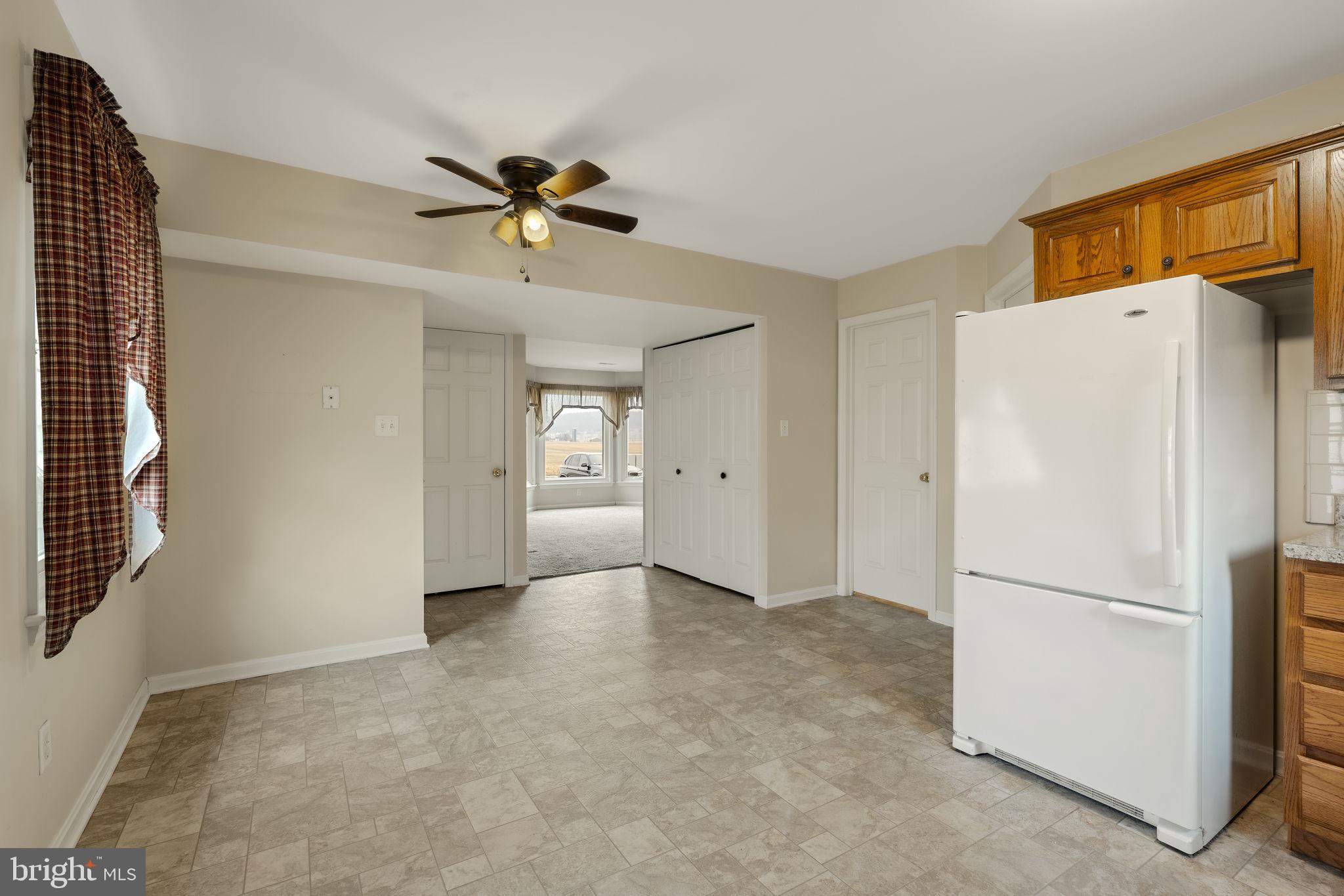 136 Bridle Path New Holland, PA 17557 - Photo 9 of 38 a view of a livingroom with a refrigerator a ceiling fan and a refrigerator