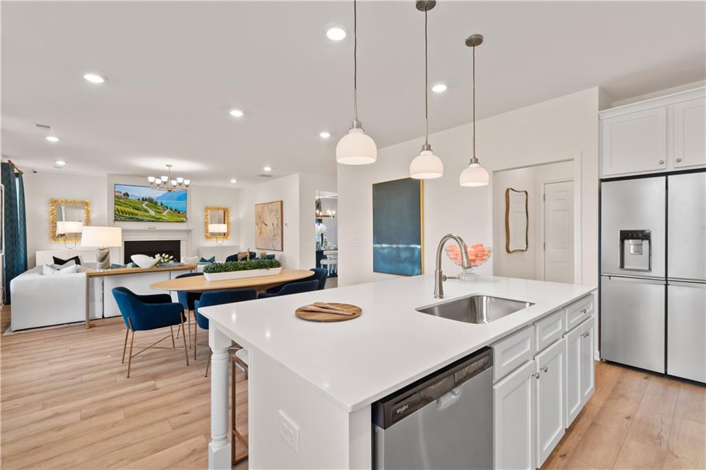 200 Chiswick Loop Stockbridge, GA 30281 - Photo 19 of 44 a kitchen with stainless steel appliances granite countertop a sink a stove and a refrigerator