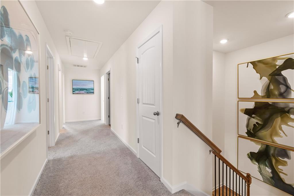 200 Chiswick Loop Stockbridge, GA 30281 - Photo 24 of 44 a view of a hallway with wooden floor and staircase
