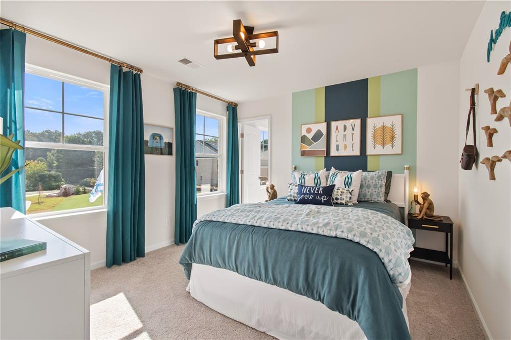 200 Chiswick Loop Stockbridge, GA 30281 - Photo 30 of 44 a bed sitting in a bedroom next to a window