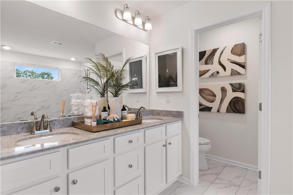 200 Chiswick Loop Stockbridge, GA 30281 - Photo 37 of 44 a bathroom with a granite countertop sink a mirror and shower