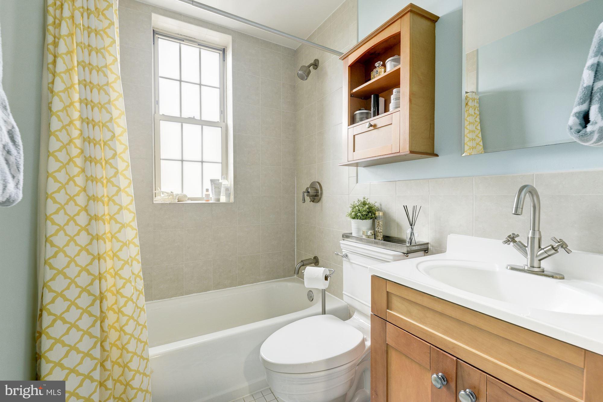 1673 Park Road Northwest, Unit 505 Washington, DC 20010 - Photo 11 of 17 a bathroom with a sink a toilet and shower