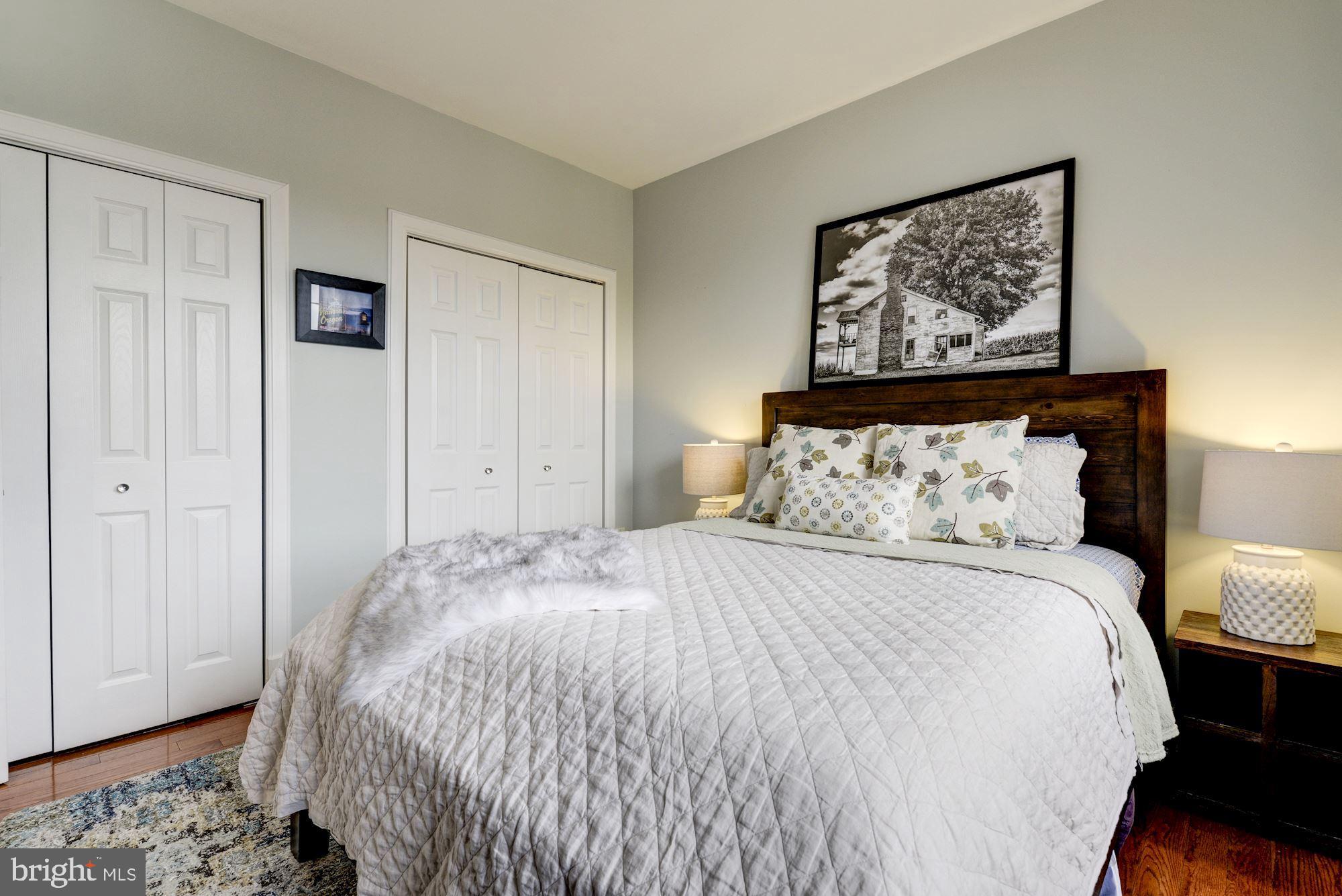 1673 Park Road Northwest, Unit 505 Washington, DC 20010 - Photo 9 of 17 a bed room with a bed and a painting on the wall