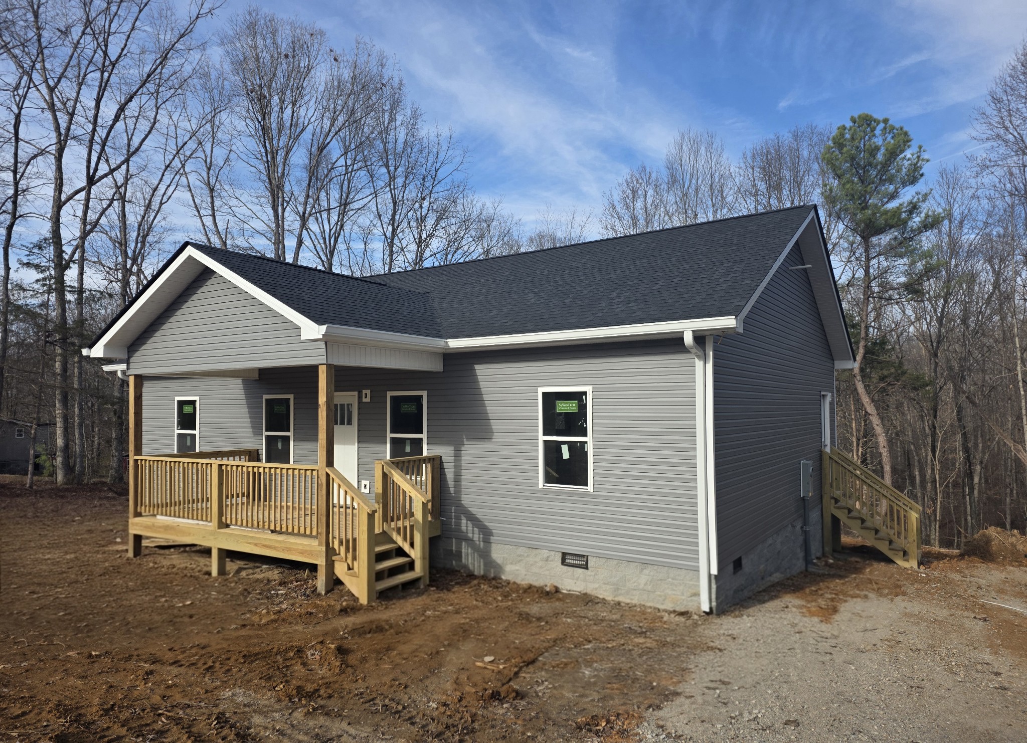 a view of a house with a yard and wooden fence