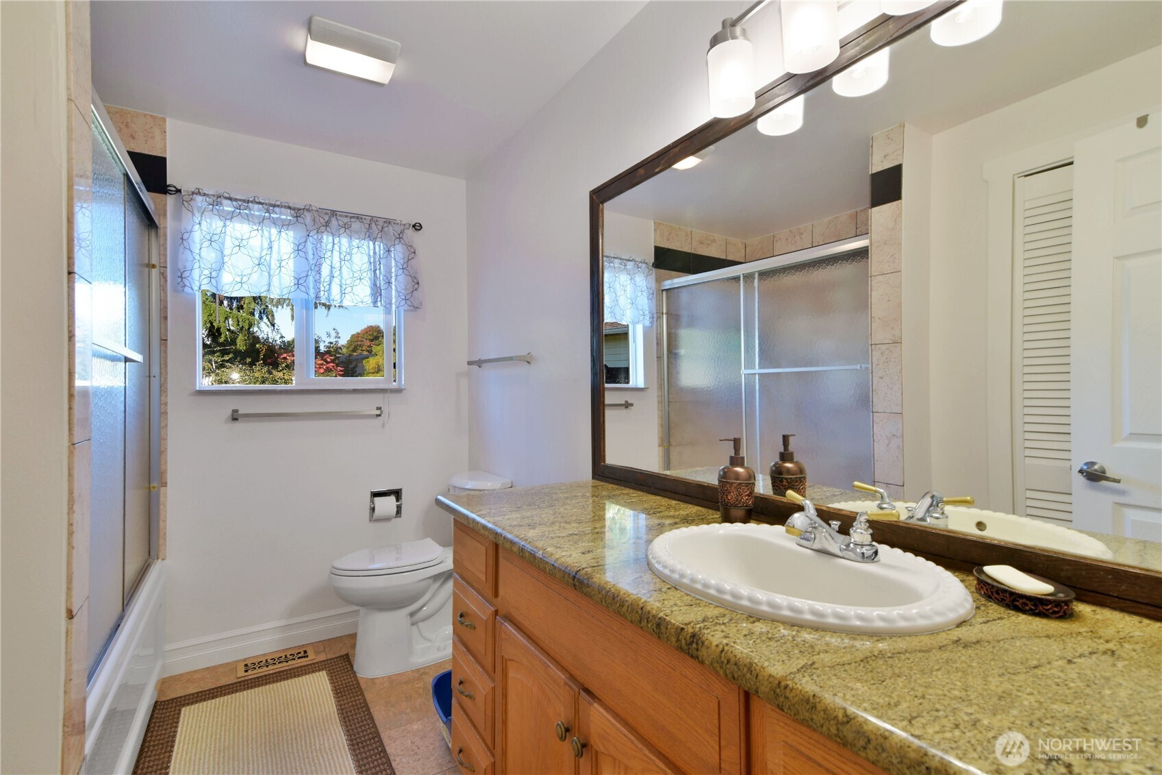 23116 80th Place West Edmonds, WA 98026 - Photo 20 of 34 a bathroom with a granite countertop sink mirror and a bathtub