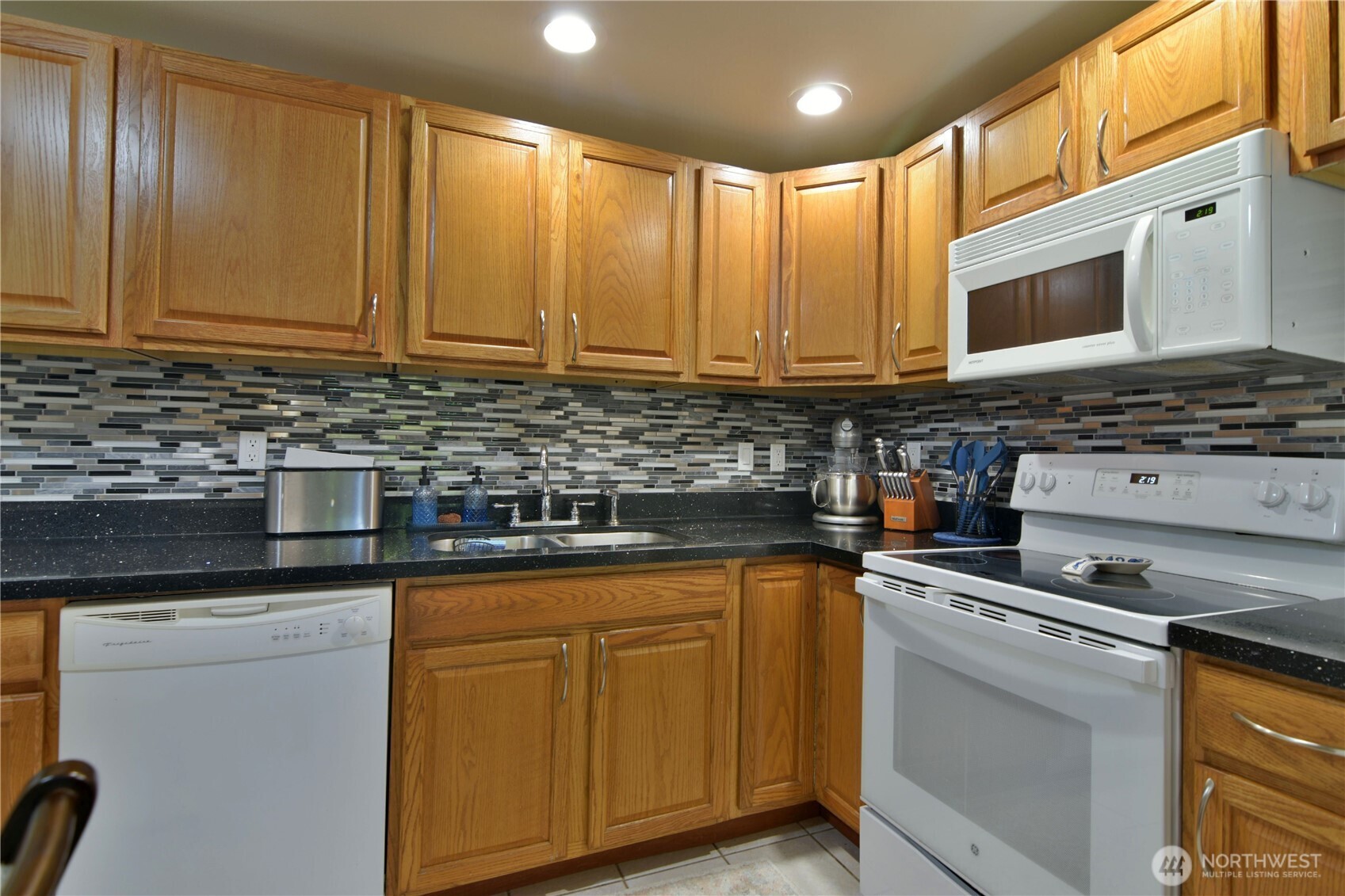 23116 80th Place West Edmonds, WA 98026 - Photo 27 of 34 a kitchen with stainless steel appliances granite countertop a stove a sink and a microwave