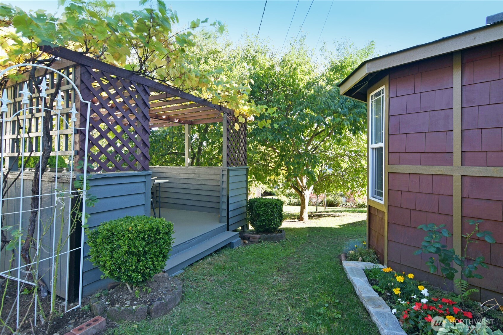 23116 80th Place West Edmonds, WA 98026 - Photo 33 of 34 a view of a backyard with wooden fence and flowers
