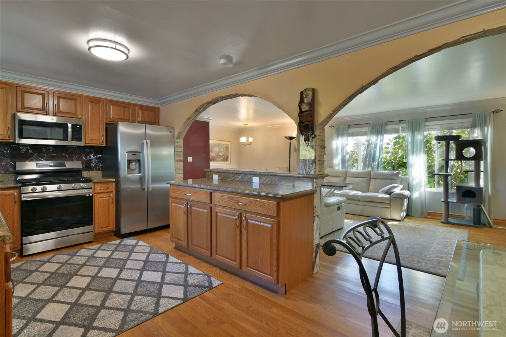 23116 80th Place West Edmonds, WA 98026 - Photo 8 of 34 a kitchen with stainless steel appliances kitchen island granite countertop a stove a sink and a microwave