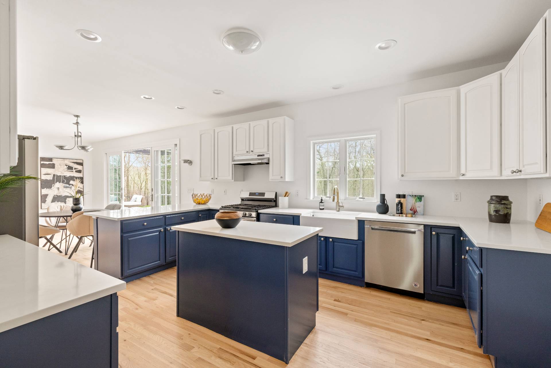 28 Quail Run Hampton Bays, NY 11946 - Photo 11 of 22 a kitchen with a sink a counter top space stainless steel appliances and cabinets