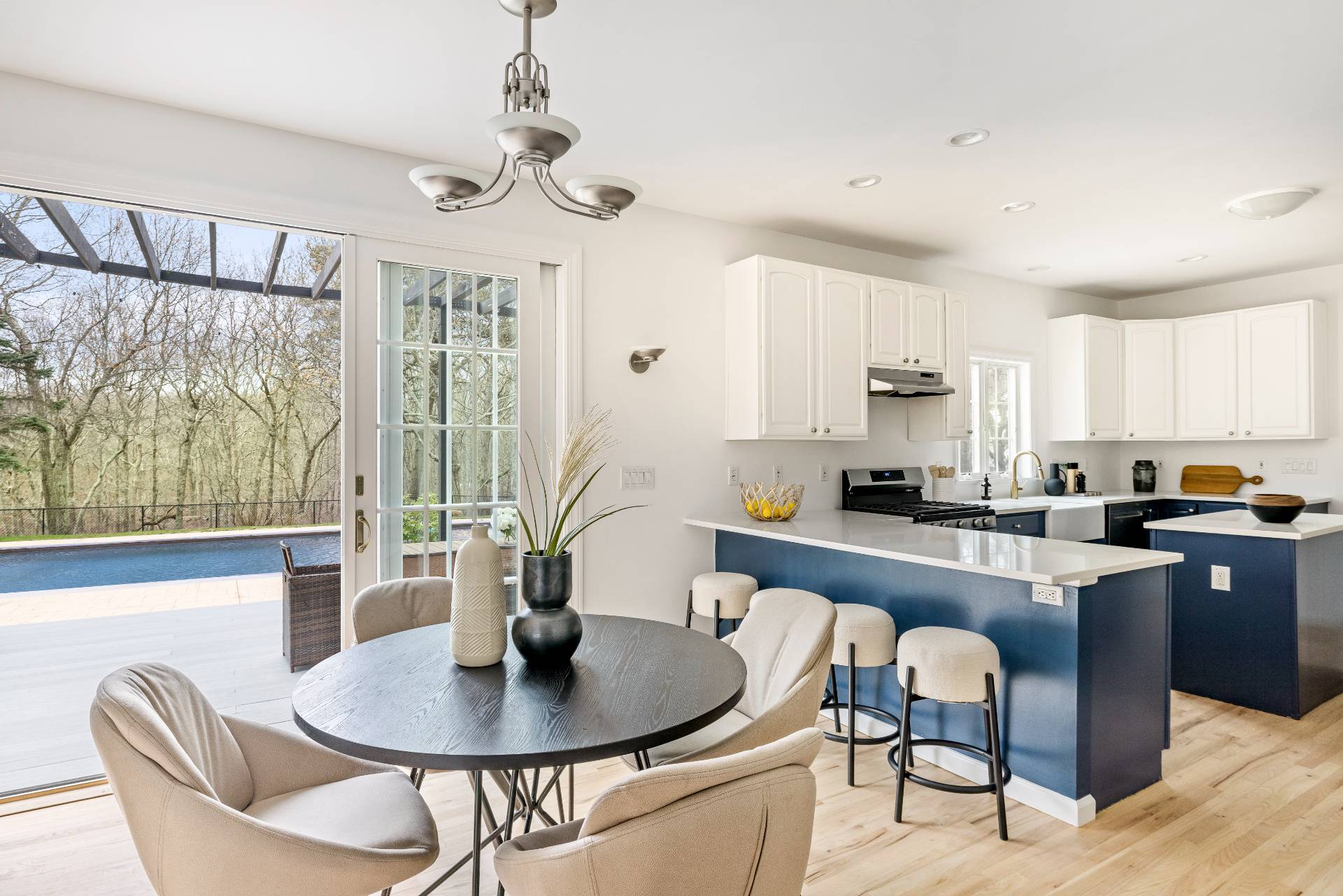 28 Quail Run Hampton Bays, NY 11946 - Photo 12 of 22 a kitchen with a table chairs stove and cabinets