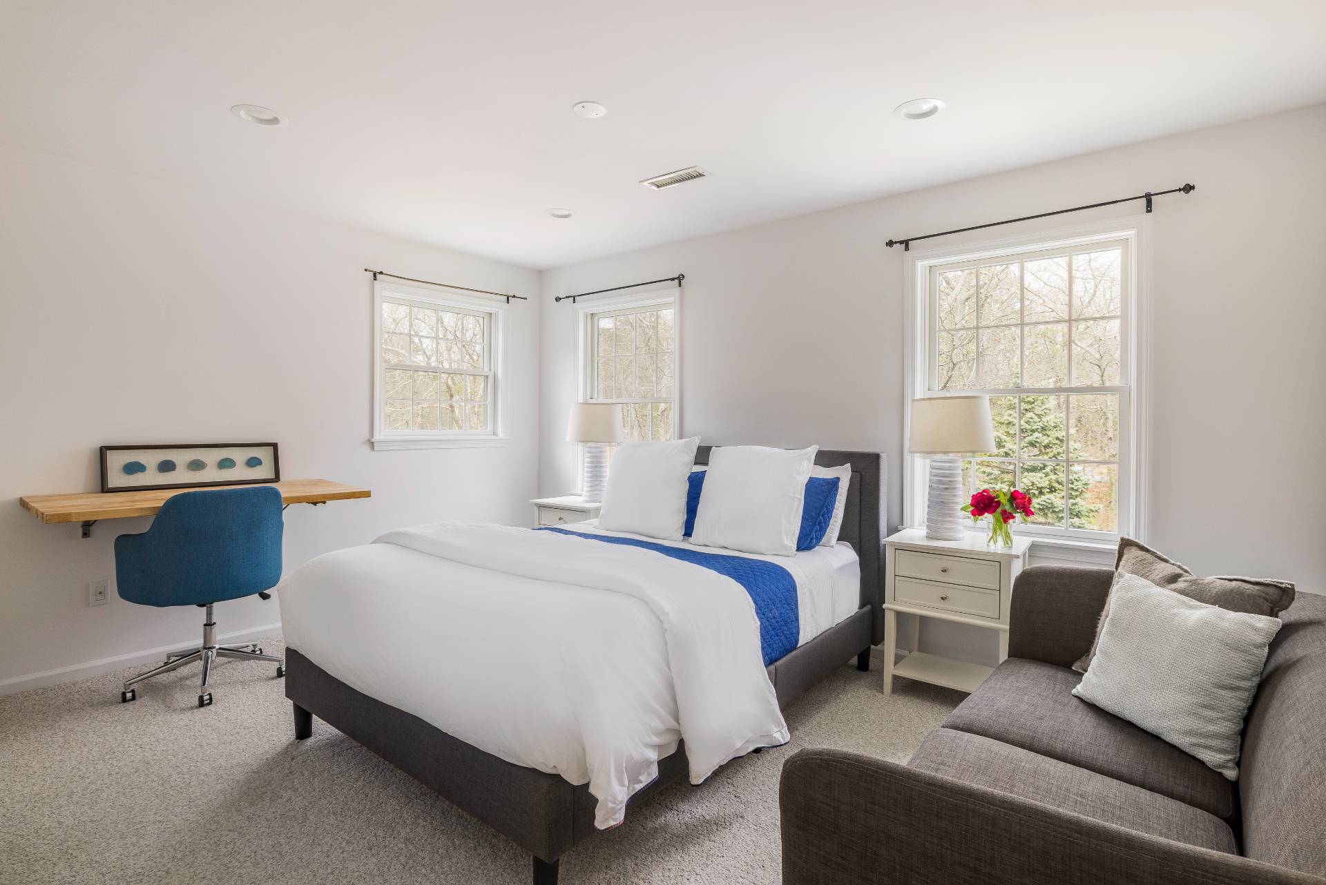 28 Quail Run Hampton Bays, NY 11946 - Photo 19 of 22 a bedroom with a bed a couch and a window