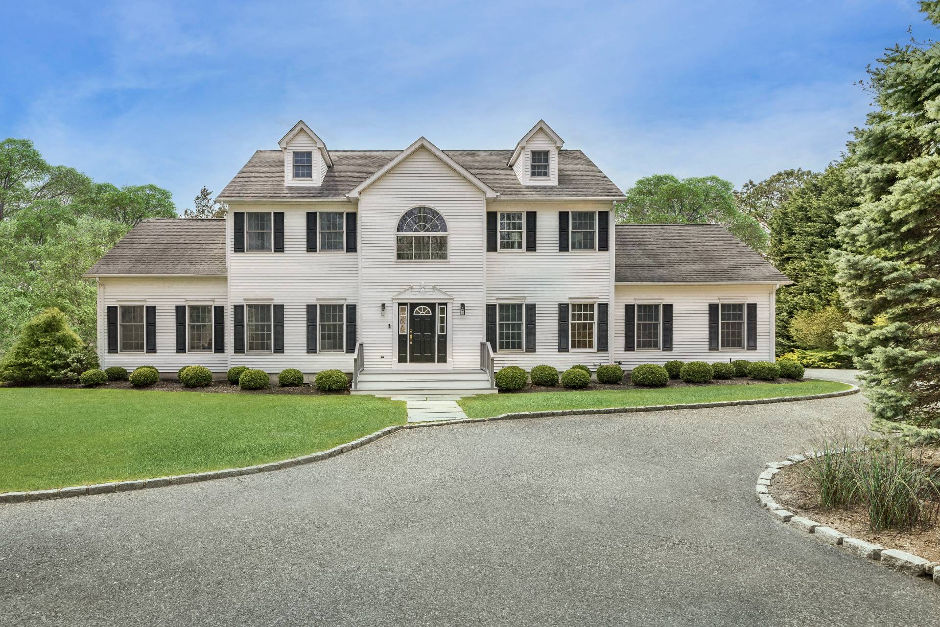 28 Quail Run Hampton Bays, NY 11946 - Photo 2 of 22 a front view of a house with a yard