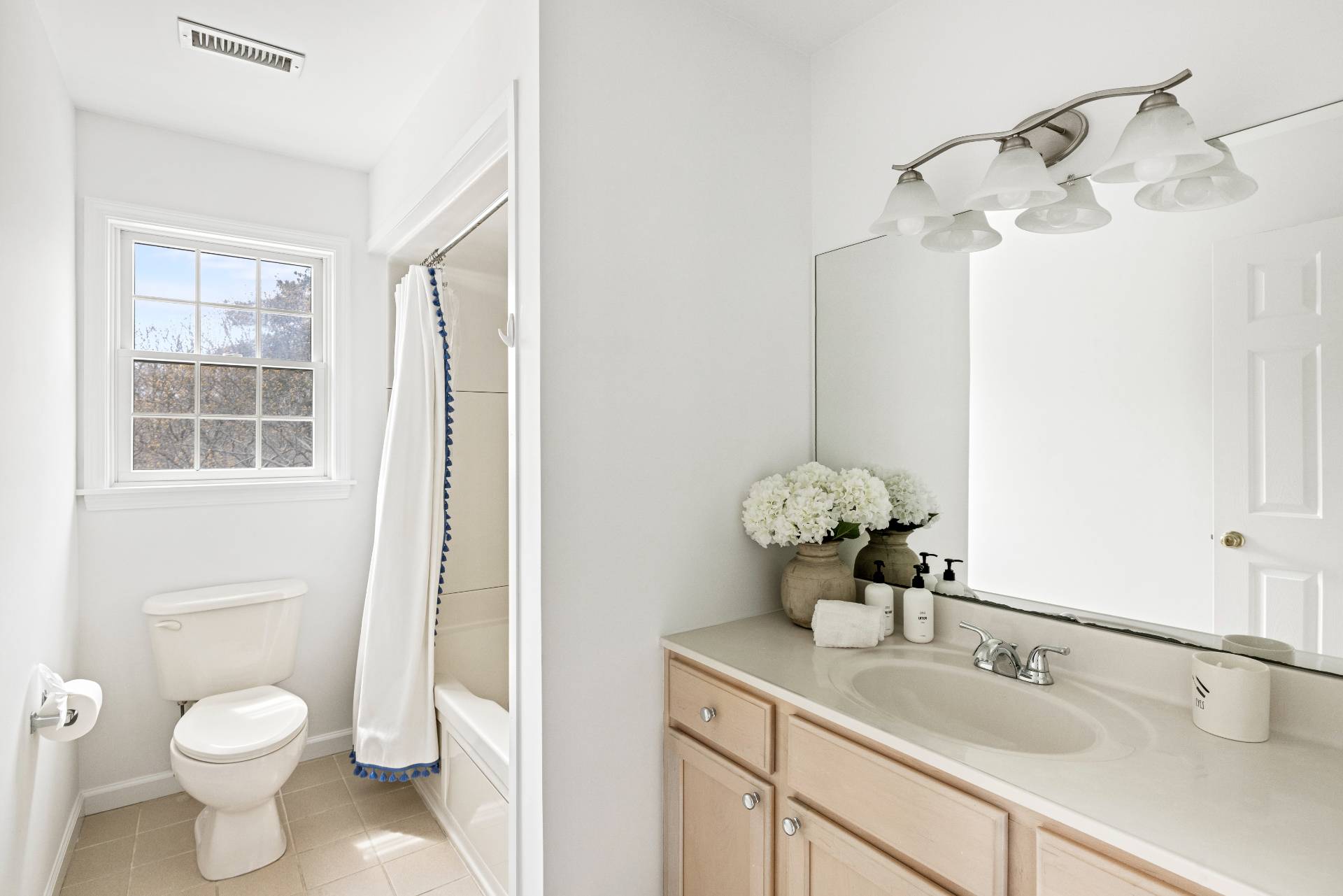 28 Quail Run Hampton Bays, NY 11946 - Photo 21 of 22 a bathroom with a toilet sink and mirror