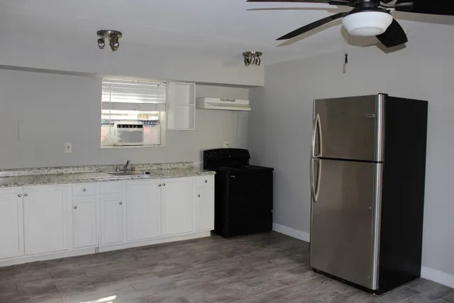 a kitchen with a refrigerator and a sink