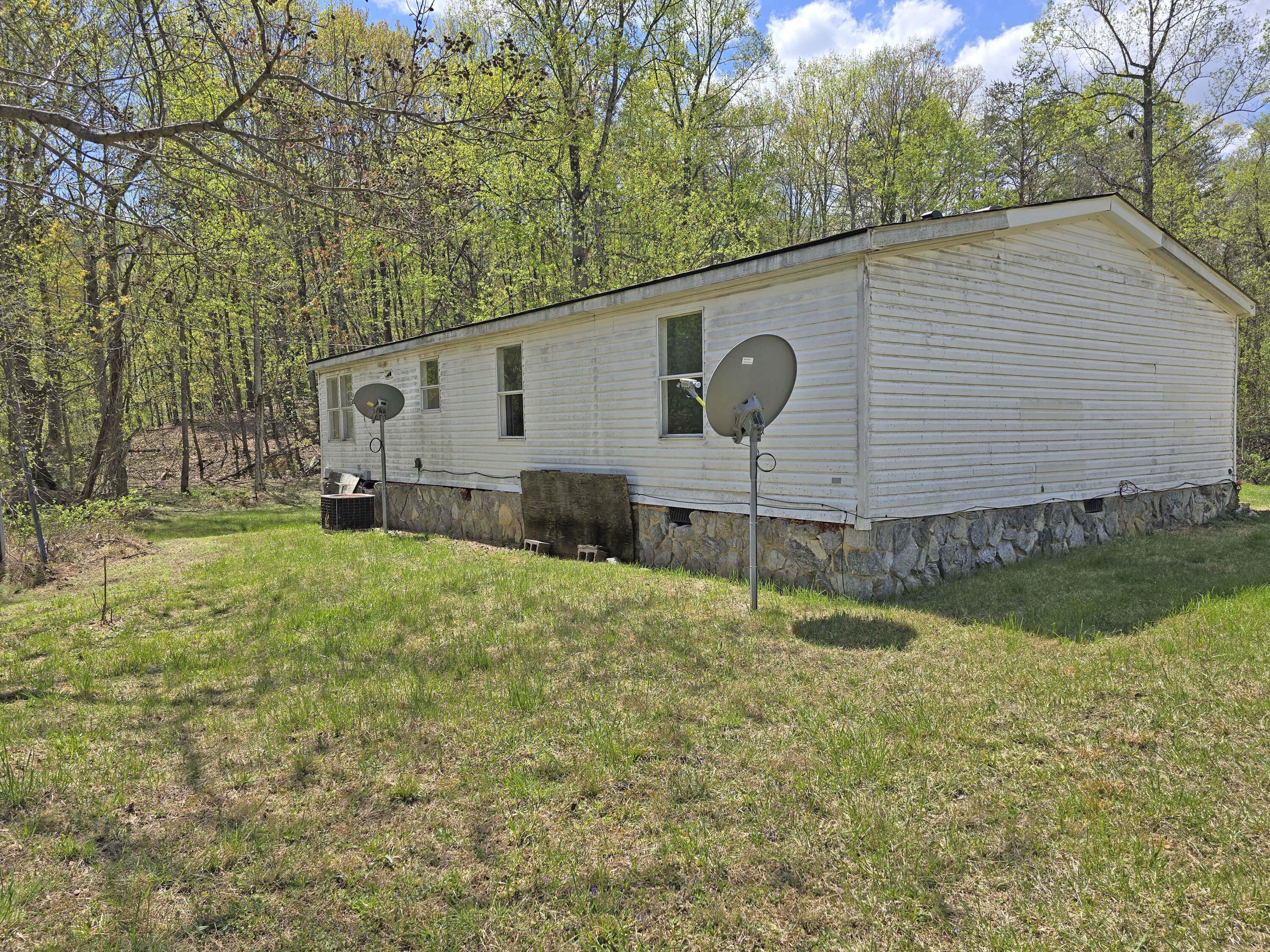 1188 Easter Lane Blue Ridge, VA 24064 - Photo 7 of 33 a backyard of a house with wooden fence and large trees