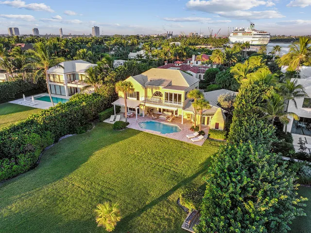 an aerial view of a house with a garden and lake view