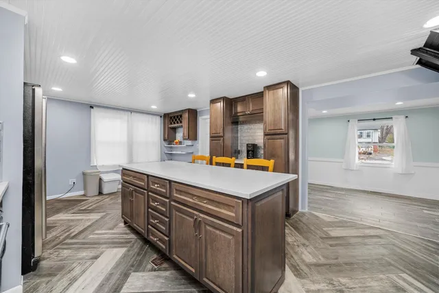 a kitchen with stainless steel appliances granite countertop a sink and a refrigerator