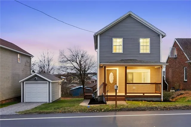a front view of a house with a yard