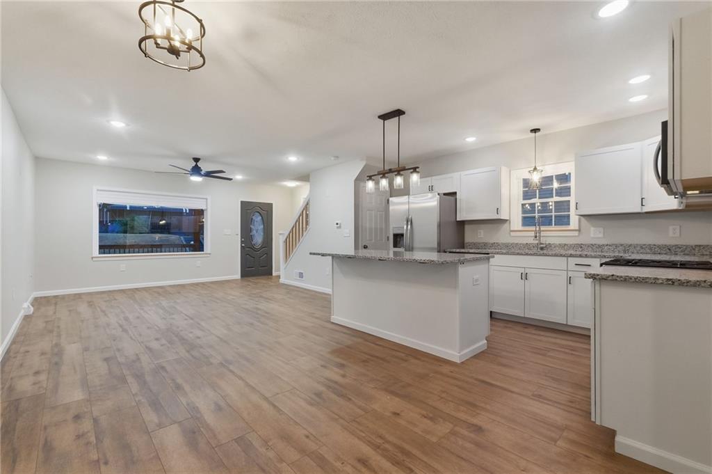 612 Virginia Avenue Rochester, PA 15074 - Photo 13 of 36 a kitchen with kitchen island granite countertop a sink a counter space appliances and cabinets