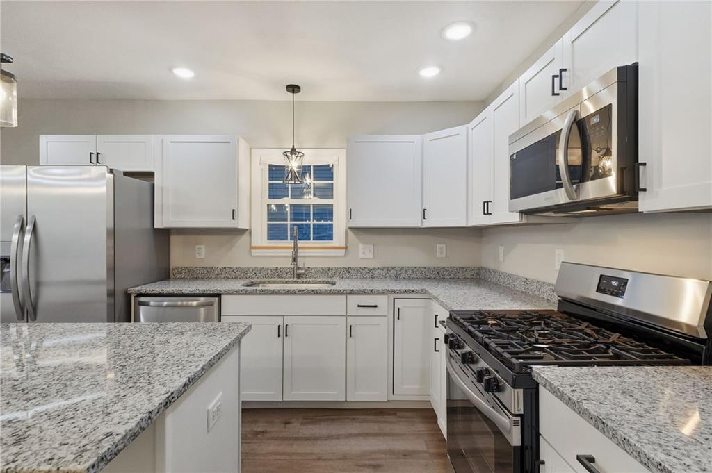 612 Virginia Avenue Rochester, PA 15074 - Photo 17 of 36 a kitchen with stainless steel appliances granite countertop a sink stove and refrigerator