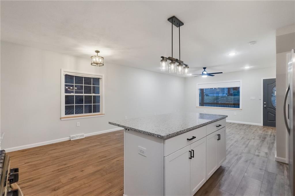 612 Virginia Avenue Rochester, PA 15074 - Photo 19 of 36 a kitchen with stainless steel appliances a stove refrigerator and wooden floor