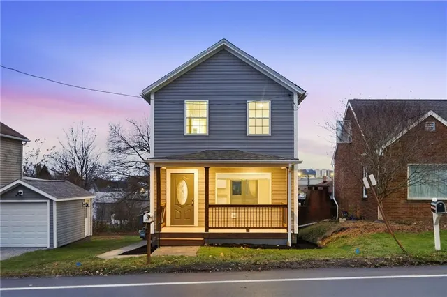 a front view of a house with a yard