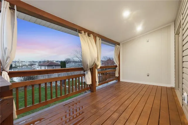 a view of a hallway with wooden floor and entryway