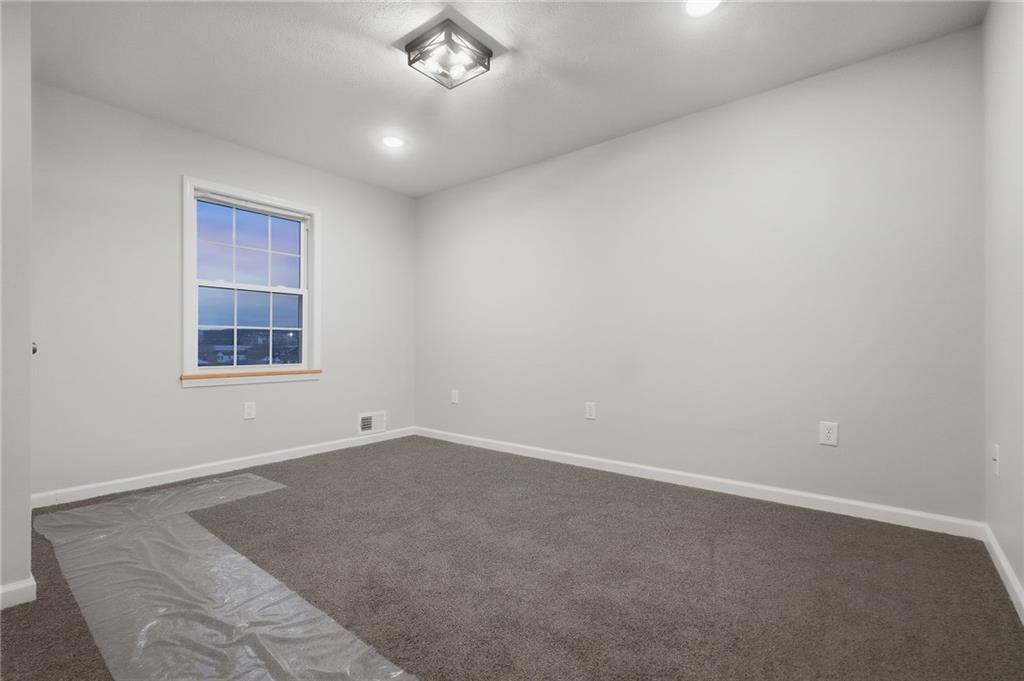 612 Virginia Avenue Rochester, PA 15074 - Photo 28 of 36 an empty room with a chandelier fan and windows