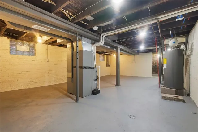 a view of a big house with a big yard and large trees