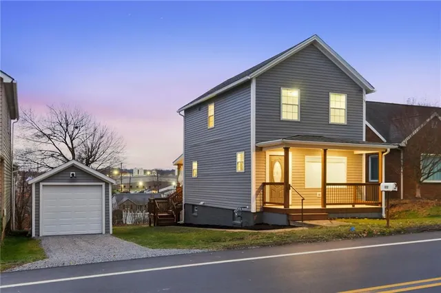 a front view of a house with a yard