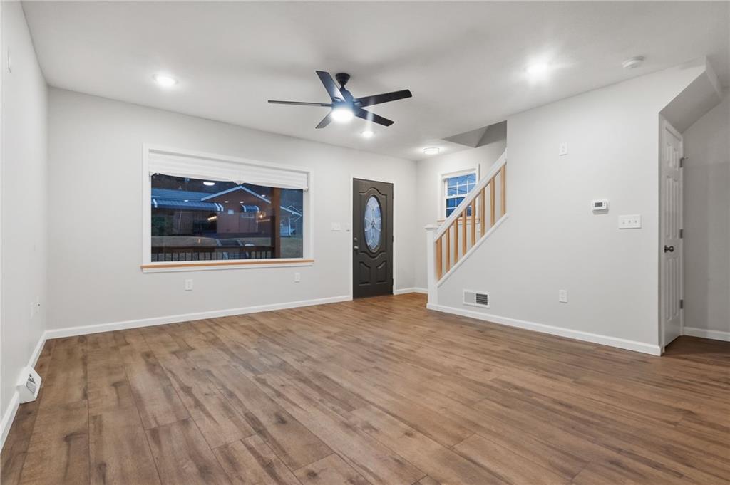 612 Virginia Avenue Rochester, PA 15074 - Photo 9 of 36 a view of an empty room with wooden floor and a ceiling fan